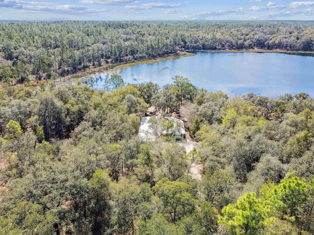 aerial view with a water view and a forest view