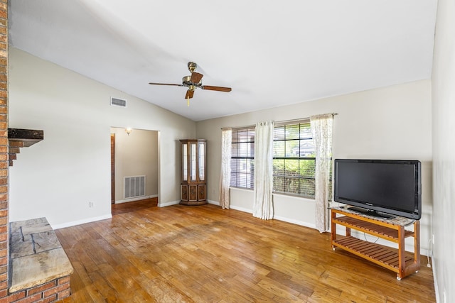 unfurnished living room with ceiling fan, lofted ceiling, wood-type flooring, and visible vents