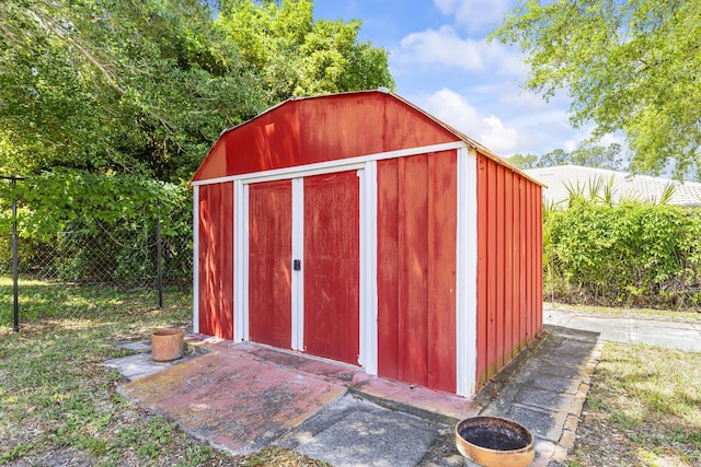 view of shed featuring fence