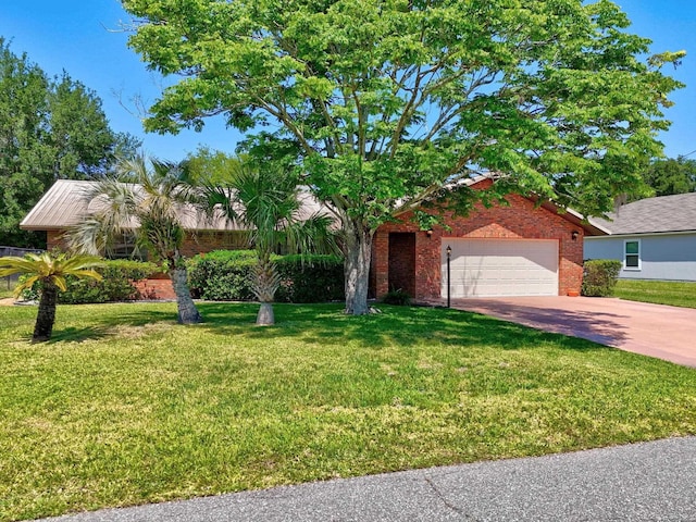 obstructed view of property with an attached garage, a front lawn, brick siding, and concrete driveway