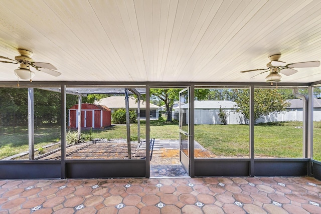 unfurnished sunroom featuring a wealth of natural light and ceiling fan