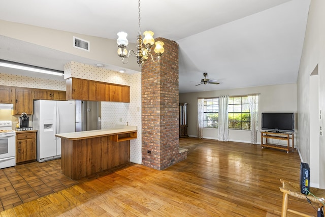 kitchen with light countertops, visible vents, white appliances, a peninsula, and open floor plan