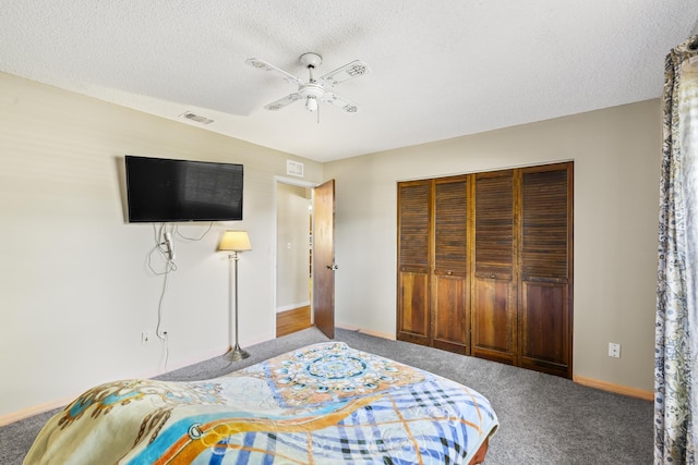 carpeted bedroom with a textured ceiling, baseboards, visible vents, a ceiling fan, and a closet