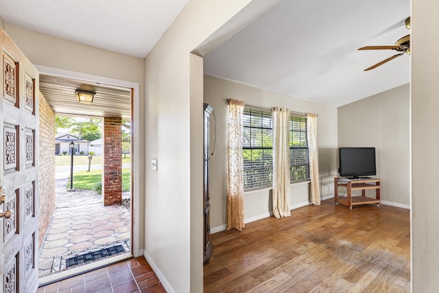 foyer featuring a ceiling fan and baseboards