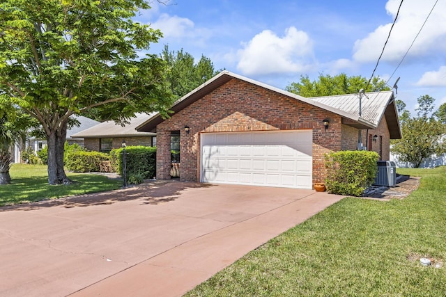 ranch-style home featuring brick siding, an attached garage, a front yard, and concrete driveway