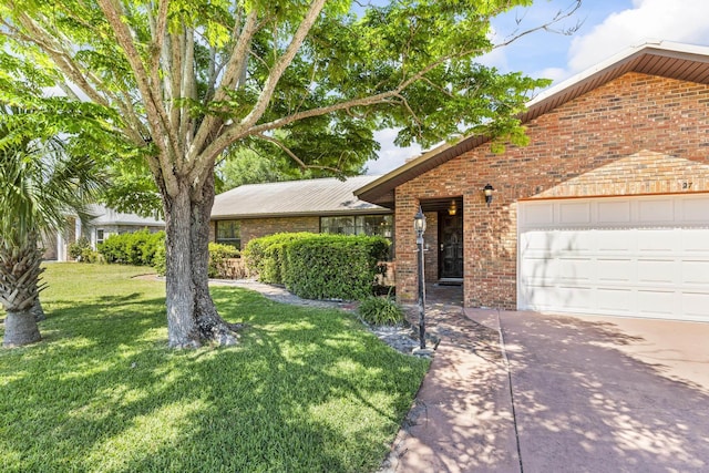 view of front of property featuring a front lawn, brick siding, driveway, and an attached garage