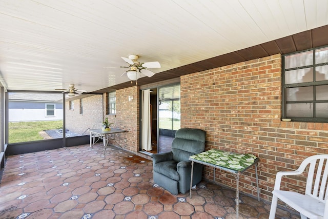 sunroom / solarium featuring ceiling fan