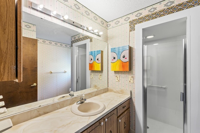 full bathroom featuring wallpapered walls, vanity, and a shower stall