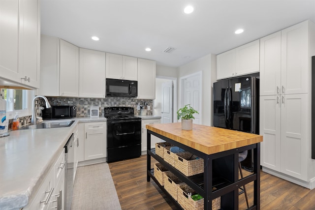 110 Arredondo Ave, Saint Augustine, FL 32080 - kitchen featuring a sink, white cabinetry, light countertops, and black appliances
