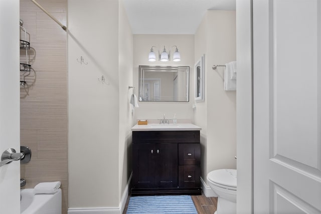 110 Arredondo Ave, Saint Augustine, FL 32080 - bathroom featuring vanity, toilet, baseboards, washtub / shower combination, and wood finished floors
