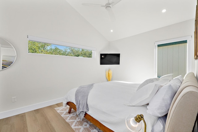 bedroom with light wood-type flooring, vaulted ceiling, and ceiling fan