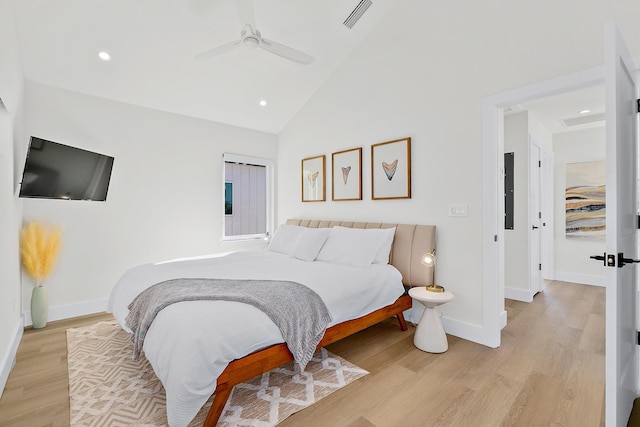 bedroom with ceiling fan, light hardwood / wood-style flooring, and high vaulted ceiling