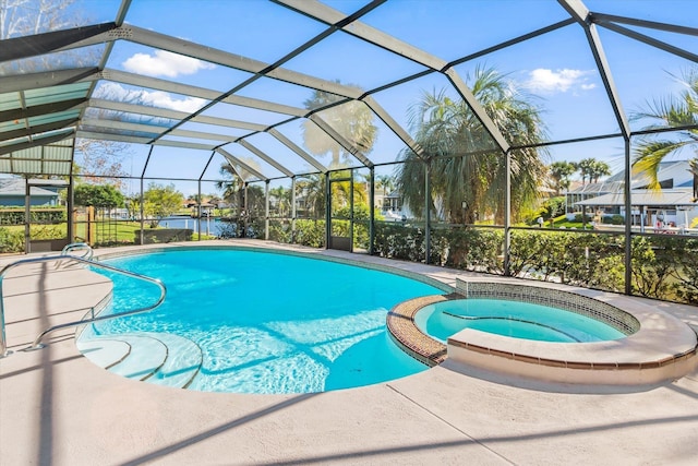 view of swimming pool with an in ground hot tub and a lanai