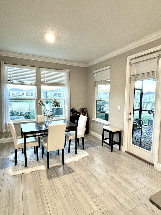 dining space featuring a textured ceiling, light hardwood / wood-style flooring, plenty of natural light, and crown molding