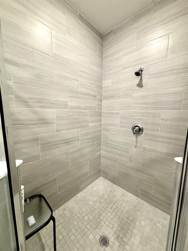 bathroom with a tile shower