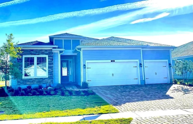 view of front of property with a garage and a front lawn