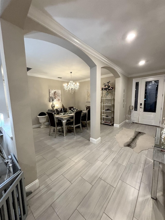 dining area with ornamental molding and an inviting chandelier