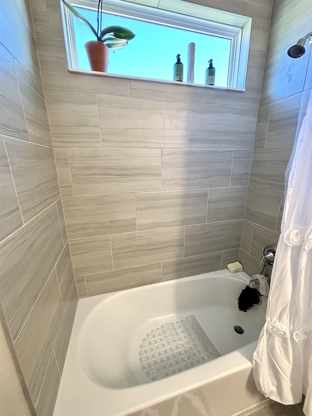 bathroom with shower / bath combination with curtain