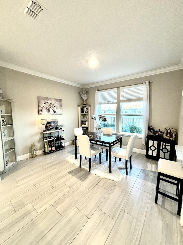 dining room featuring a textured ceiling and ornamental molding