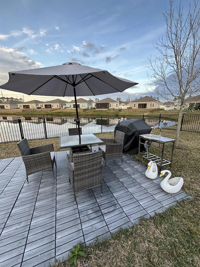 view of patio / terrace with a deck with water view and area for grilling