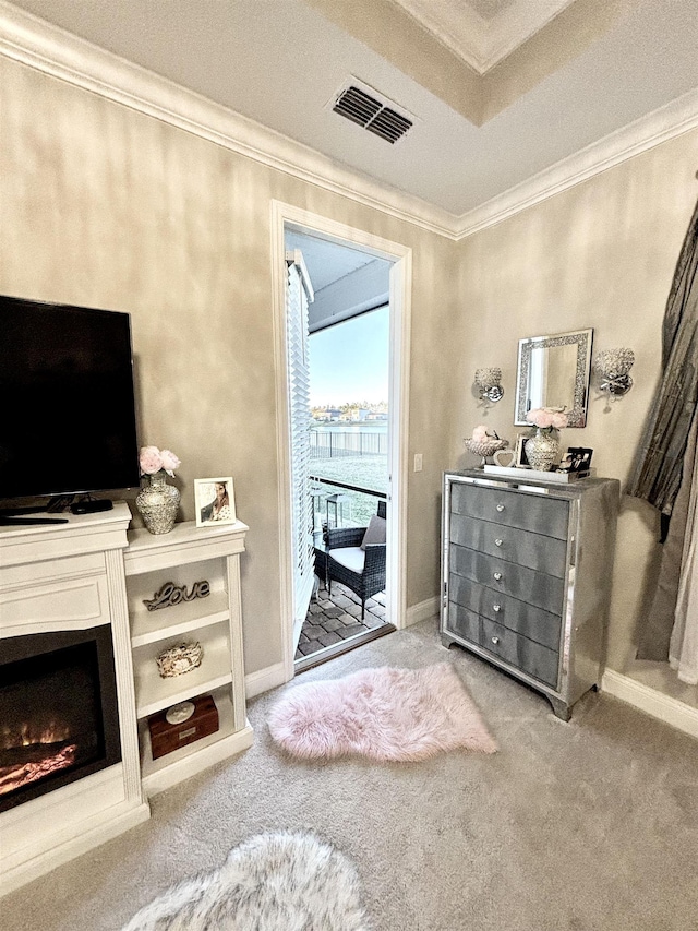 living area with crown molding and carpet