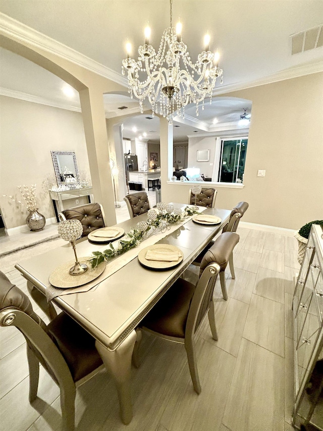 dining space with ornamental molding, light tile patterned floors, and a chandelier