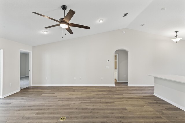 unfurnished living room with hardwood / wood-style floors, vaulted ceiling, and ceiling fan