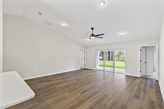 unfurnished living room with ceiling fan, lofted ceiling, and dark wood-type flooring