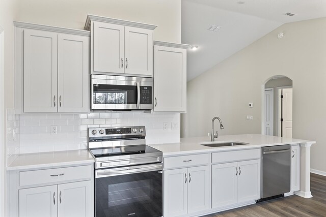 kitchen featuring backsplash, white cabinetry, sink, and appliances with stainless steel finishes