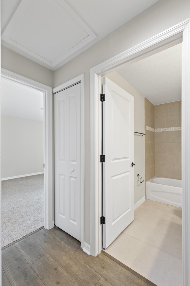 hallway with hardwood / wood-style flooring