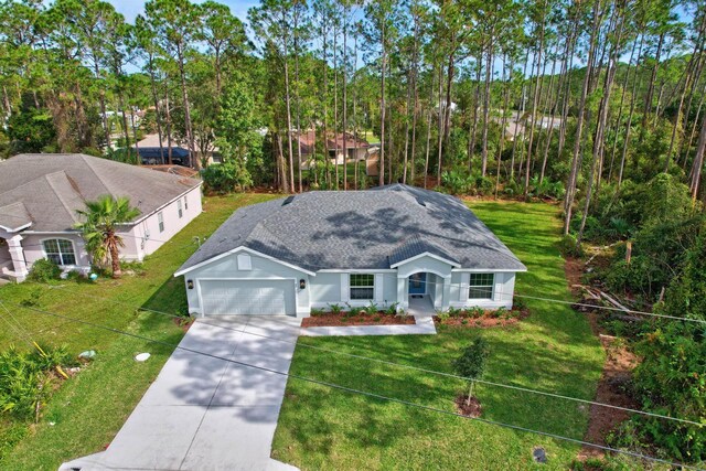 view of front facade featuring a garage and a front lawn