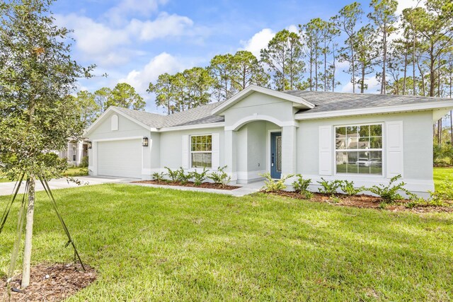 ranch-style home featuring a front lawn and a garage