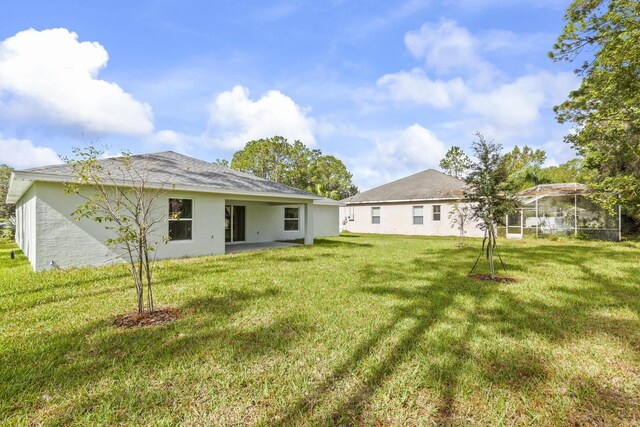 rear view of property with a lawn