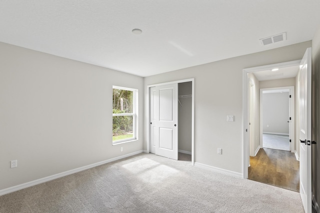 unfurnished bedroom featuring a closet and carpet