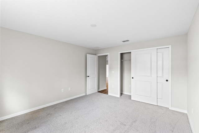 unfurnished bedroom with carpet and a closet