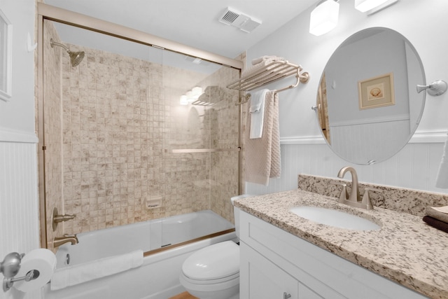 bathroom featuring wainscoting, visible vents, vanity, and toilet