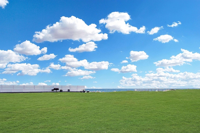 view of yard with a rural view and a water view