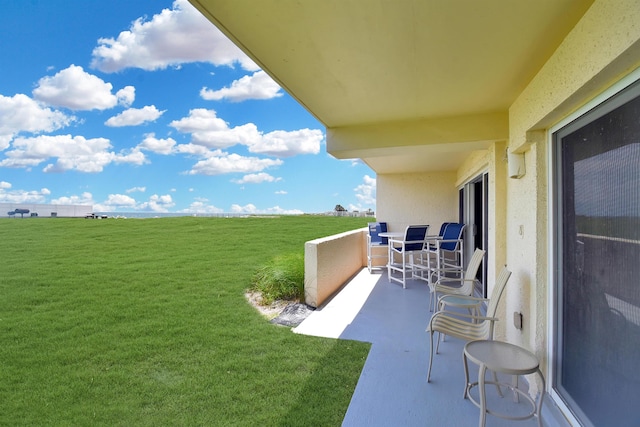 view of yard with a rural view and a balcony