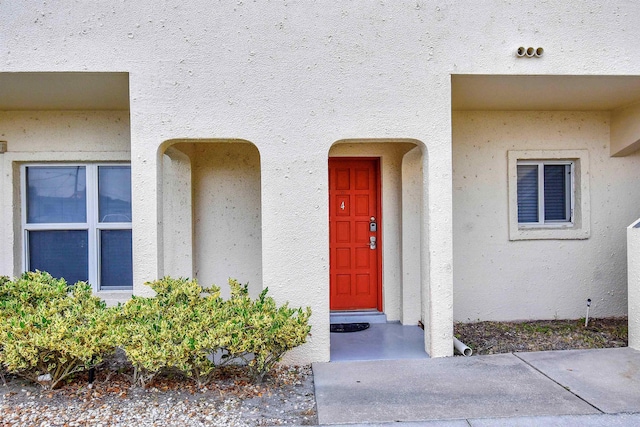 view of exterior entry with stucco siding