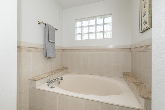 bathroom featuring tiled tub