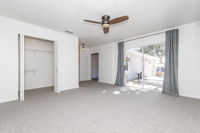 unfurnished bedroom featuring ceiling fan, access to exterior, carpet floors, a textured ceiling, and a closet