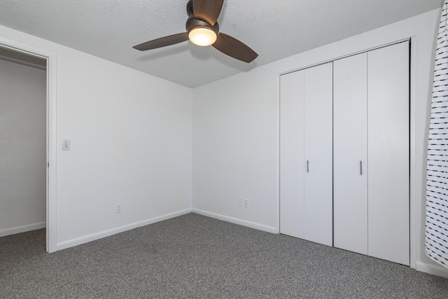 unfurnished bedroom featuring ceiling fan, a closet, a textured ceiling, and carpet