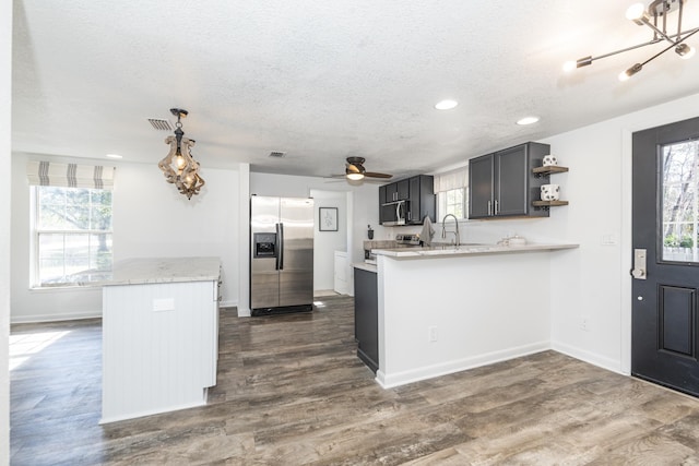 kitchen with plenty of natural light, stainless steel appliances, and kitchen peninsula