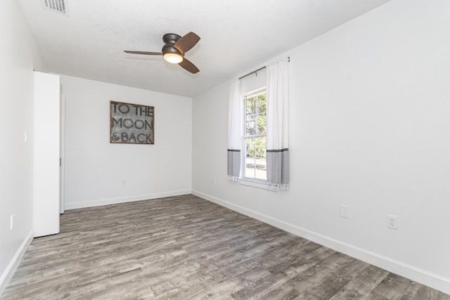 spare room with ceiling fan, a textured ceiling, and light hardwood / wood-style flooring