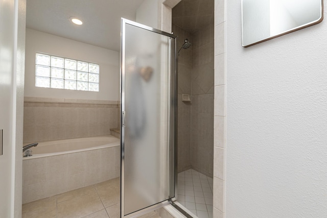 bathroom with tile patterned floors and independent shower and bath