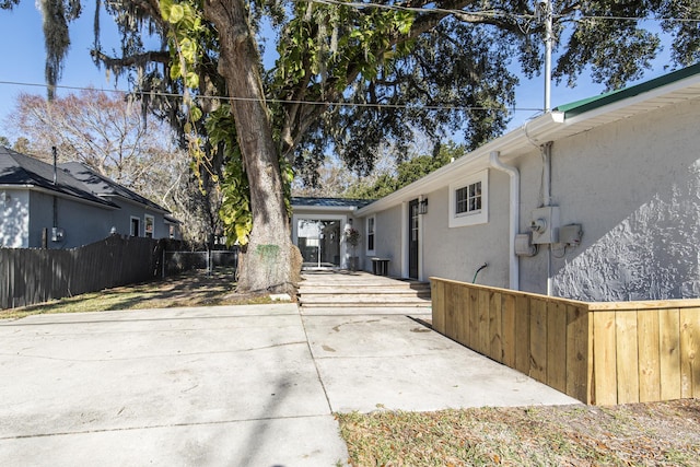 view of property exterior with a patio area