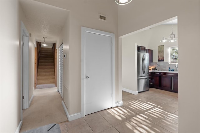 100 Saturn Rd, Saint Augustine, FL 32086 - hall with stairs and light tile patterned flooring