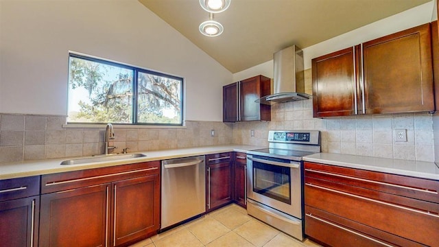 100 Saturn Rd, Saint Augustine, FL 32086 - kitchen with stainless steel appliances, wall chimney exhaust hood, lofted ceiling, light countertops, and light tile patterned flooring