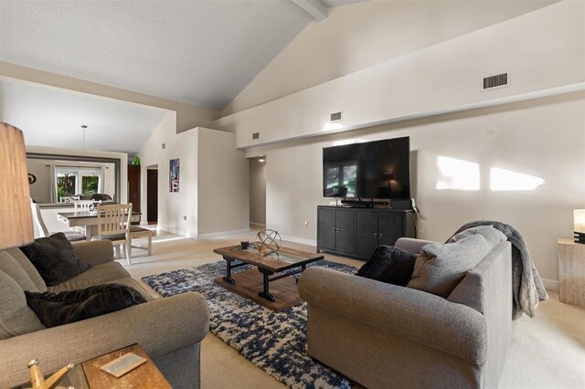 100 Saturn Rd, Saint Augustine, FL 32086 - living area featuring light carpet, beam ceiling, and high vaulted ceiling