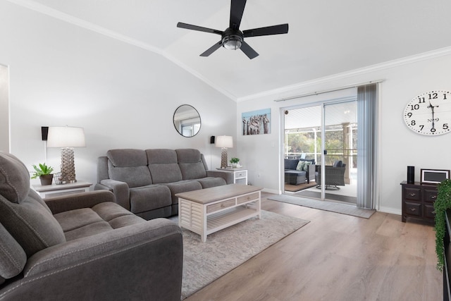 living room featuring ceiling fan, ornamental molding, vaulted ceiling, and light hardwood / wood-style flooring